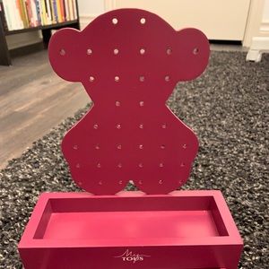 Tous jewelry holder, in the color dark magenta.